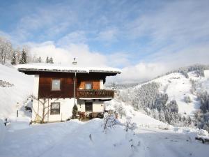 a log cabin with snow on the roof at Apartment in Sankt Johann im Pongau near Ski Area in Wagrain +69 photos