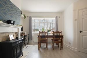 a dining room with a table and chairs and a window at poplar in Mexborough