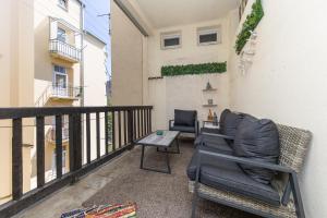 a balcony with two chairs and a table at Rooftop Flower Power Apartment in Brno