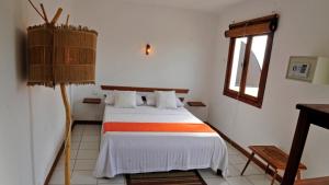 a bedroom with a bed and a window at Ocean501 in Toamasina +7 photos