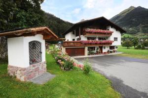 a house with flowers on the side of the road at Haus Helene in Sankt Gallenkirch