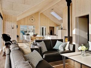 a living room with a couch and a table at 5 star holiday home in Bogense in Bogense