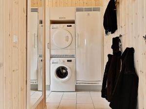a laundry room with a washer and dryer at 5 star holiday home in Bogense in Bogense