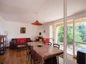 a living room with a table and a couch at Cosy Holiday Home in Cargèse Corse-du-Sud near Sea in Cargèse