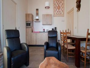a living room with a table and chairs and a kitchen at Quaint Farmhouse in Geesteren with Meadow View in Geesteren +8 photos