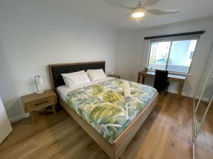 a bedroom with a large bed with a fan at Sandcastles Beachfront Luxury Retreat Apartment in Perth +81 photos