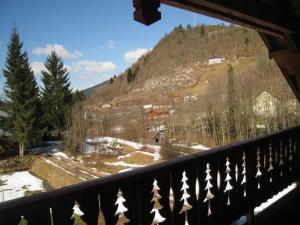 a view of a snow covered mountain from a balcony at Chalet in Ventron near La Bresse Ski Area in Ventron