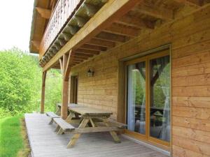 a wooden deck with a picnic bench on a house at Chalet in Ventron near La Bresse Ski Area in Ventron