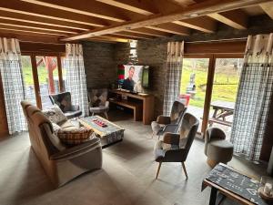 a living room with couches and chairs and a tv at Chalet in Ventron near La Bresse Ski Area in Ventron +32 photos