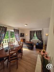 a living room with a table and chairs and a couch at Gîte Nolibo in Nogaro