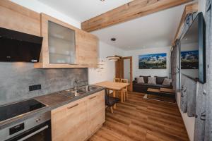 a kitchen and living room with a couch at Landhaus Goldgräber in Rauris