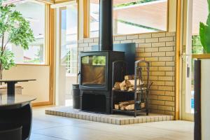 a wood stove in a room with a table at フレッチア in Futo