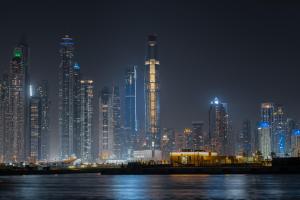 a nighttime view of a large city at night at Ciel Dubai Marina, Vignette Collection by IHG in Dubai +107 photos