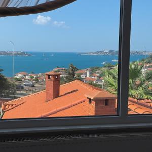 a view from a window of a building with a red roof at Reflection of the Bosphorus in Istanbul