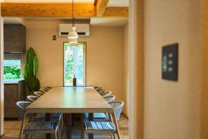 a dining room with a table and chairs at フレッチア in Futo