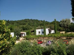 a house with two cars parked in a yard at Luxurious Holiday Home in Palinuro Italy with Swimming Pool in Centola