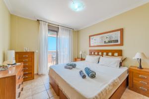 a bedroom with a bed with two pillows on it at Sotavento Horizon Views Suite in La Tejita