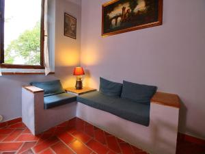 a bench in a room with a lamp on a table at Attractive apartment in old farmhouse on the estate with pool in Umbertide