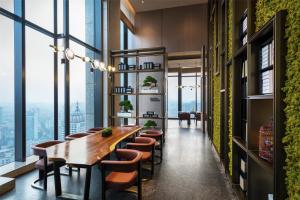 a dining room with a long table and chairs at Canopy by Hilton Chengdu City Centre in Chengdu