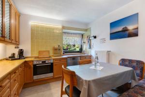 a kitchen with a table and a dining room at Apartment Alte Poststation in Wehr