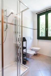 a bathroom with a glass shower and a toilet at Panoramic refuge 5-Baita Lago Blu in Bellano +37 photos