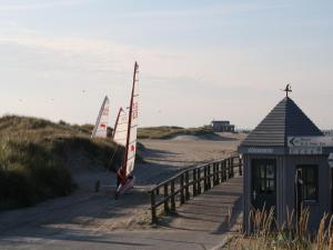 two sailboats on the beach next to a building at Semi-detached house in St Peter-Ording in Sankt Peter-Ording