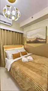 a bedroom with a bed with two towels on it at RED LUXE HAVEN Comfy stay, Netflix and Fast WiFi Ready in Manila +49 photos
