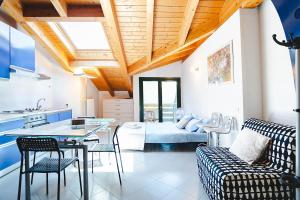a kitchen and living room with a table and chairs at Panoramic refuge 5-Baita Lago Blu in Bellano
