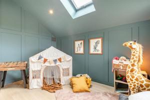 a room with a giraffe and a play tent at 5 Bed in Marwood oc-e32631 in Marwood