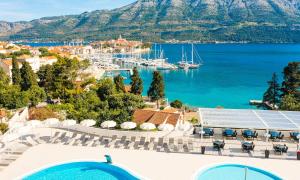 a view of a harbor with boats in the water at Marko Polo Maradiso Hotel by Aminess in Korčula