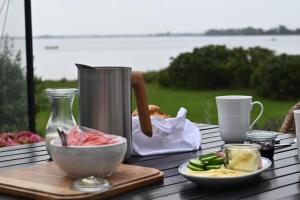 a table with a bowl of food and a bag of food at Hideaway Engvej in Guldborg