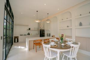 a kitchen and dining room with a table and chairs at SOOJIWA VILLA by Taman Bali in Dalung