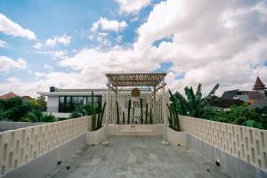 a large white entrance to a house with a fence at SOOJIWA VILLA by Taman Bali in Dalung