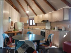 a kitchen with a table and chairs in it at yurt experience in Istiaía