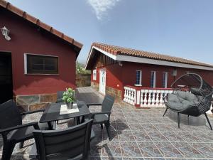 a patio with tables and chairs in front of a house at La Planta Vieja III in La Orotava