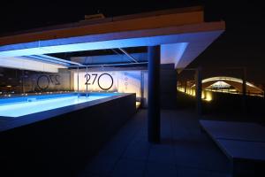 a building with a swimming pool at night at Barceló Valencia in Valencia