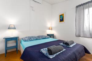 a bedroom with two beds with towels on them at Villa with a beautiful sea view near the beach - by Traveler tourist agency Krk ID 2175 in Kornić +40 photos