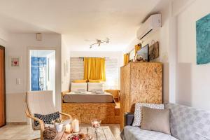 a living room with a bed and a couch at Downtown Central Suite with Private Parking in Kalamata