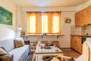 a living room with a couch and a table at Downtown Central Suite with Private Parking in Kalamata