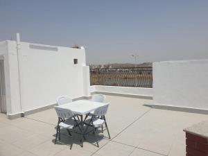 a white table and chairs on a patio at منتجع هدب للشقق المخدومة in Taif