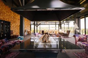 a lobby with a glass table in a room at Via Vitalité in Aizpute