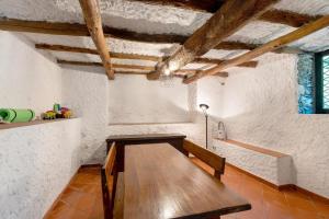 a kitchen with a wooden table in a room at Villa Franca Nature Holidays in Rezzo
