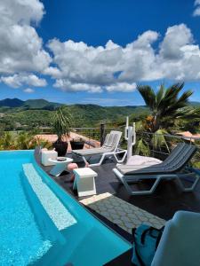 a villa with a swimming pool with a view at Latitude vue unique in Les Trois-Îlets