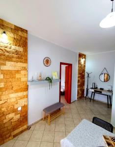 a living room with a table and a red door at Studio Eleni in Néa Agathoúpolis