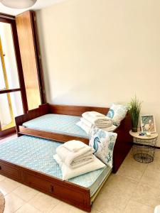 a bed with pillows on it in a room at Varandas do Pinhal in Fão