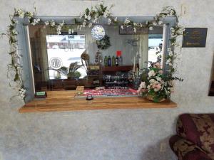a display window of a flower shop with a mirror at Melody Motor Lodge in Connellsville