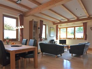 a living room with a wooden table and chairs at Ferienwohnung im malerischen Eslohe in Eslohe +30 photos
