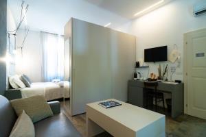 a small room with a room with a bed and a desk at Vittorio Veneto 25 in Modena +143 photos