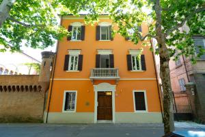 an orange building with a door and windows at Vittorio Veneto 25 in Modena