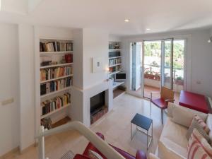 a living room with a couch and a fireplace at Sunny Terrace Near Beach in L'Escala